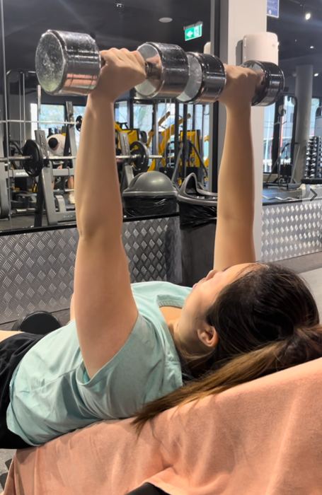Client pressing dumbbells